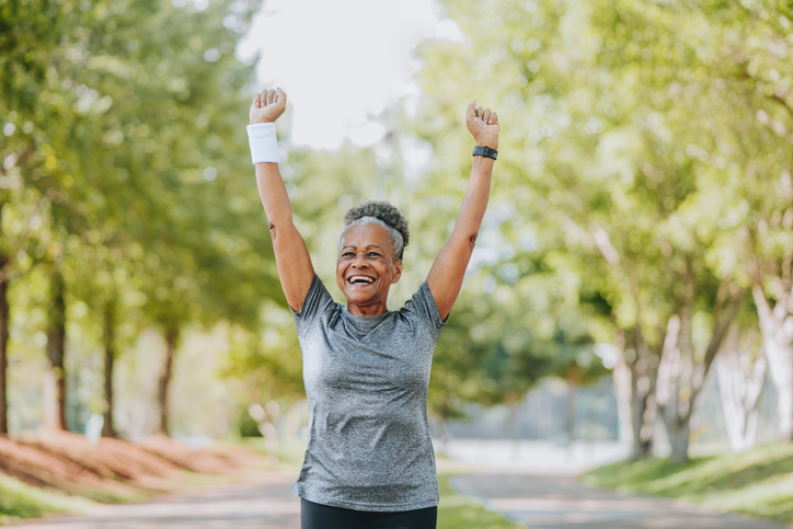 Senior woman running happy and celebrating