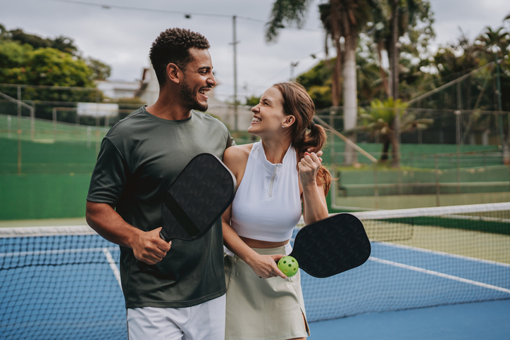 Couple playing pickleball celebrate point